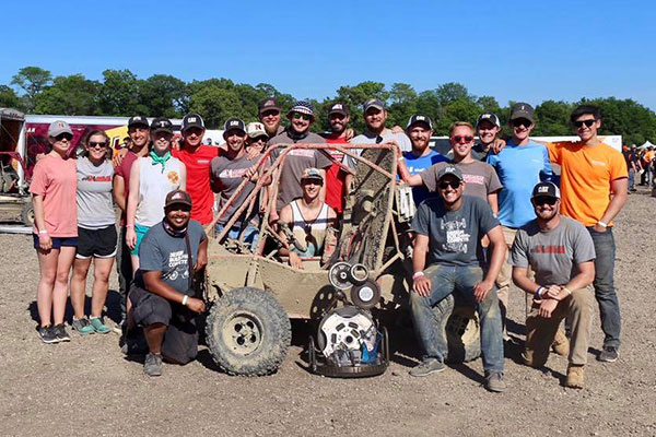 large group of students with baja vehicle