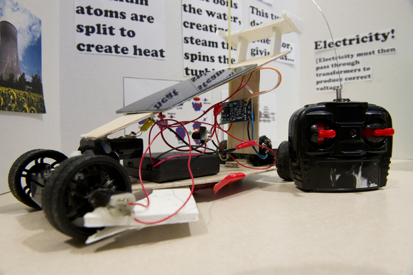 A radio-controlled, solar-powered car, sporting a regenerative motor on the front left wheel, was on display as first-year engineering students presented their team-based final projects. Photo by Brooks Canaday.