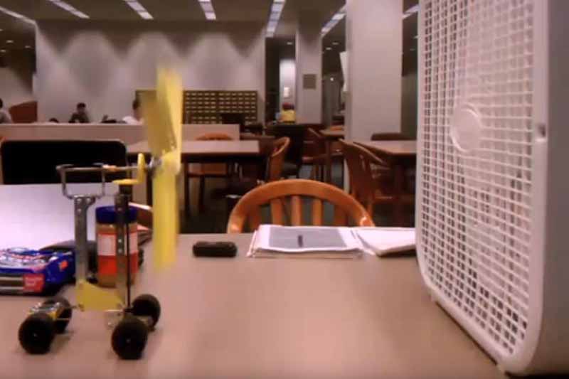 tabletop device with four wheels on table with fan in front