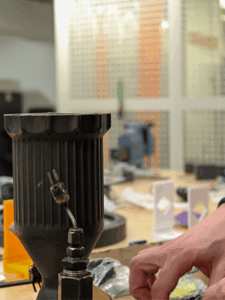 Kelso Fiedler's hand next to his pulsejet engine